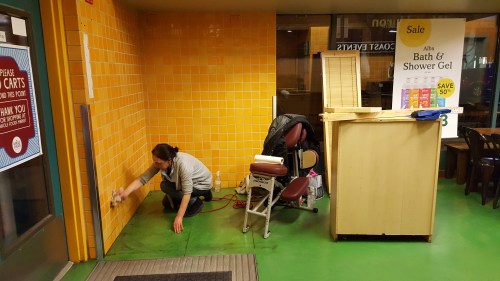 Najat cleans our space as we dismantle our WWM booth